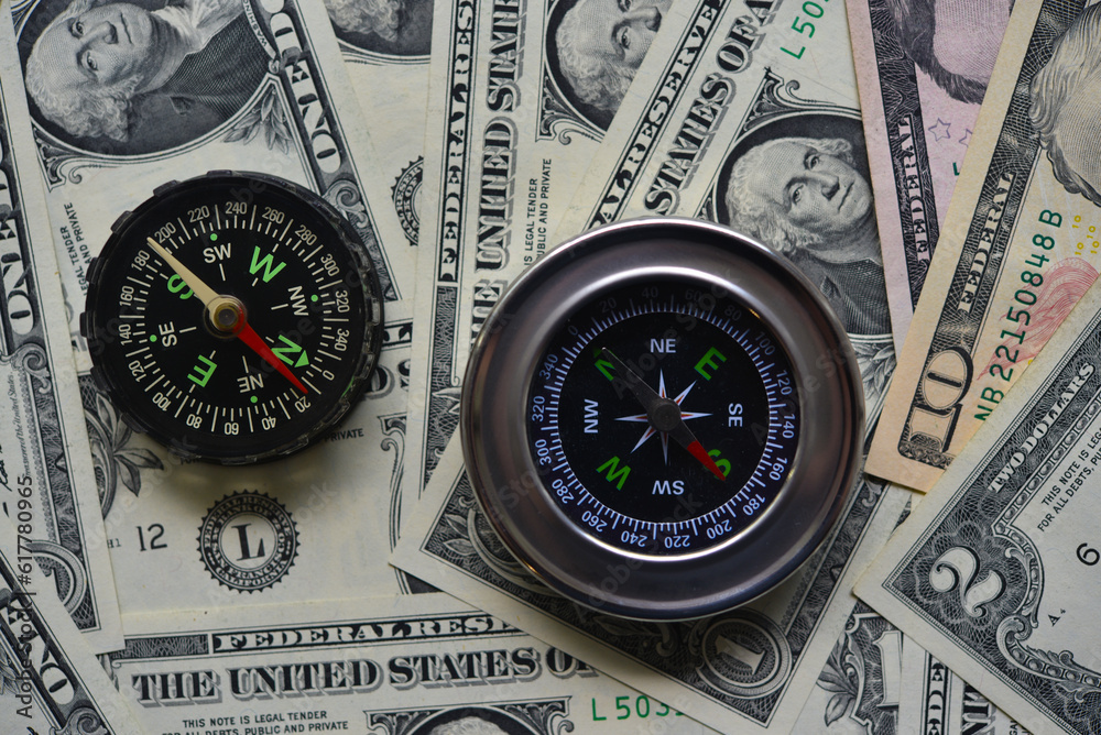 Compass and banknotes. US dollars. Navigation in the financial world. Compass and banknotes. US dollars. Navigation in the financial world.