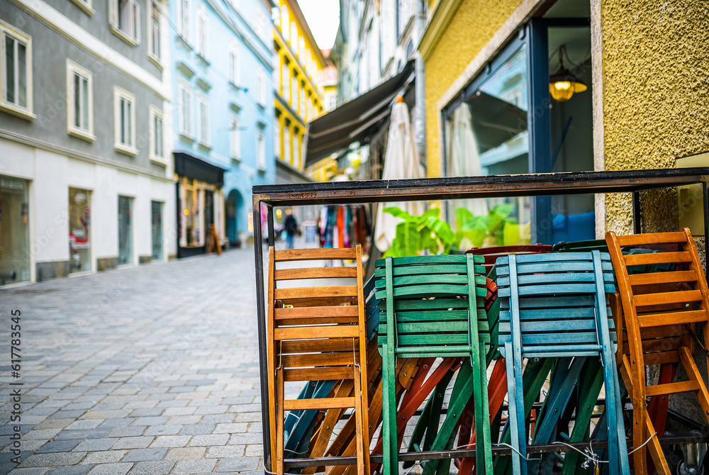 Colorful empty chairs at a restaurant in Salzburg, concept of leisure, relaxation Colorful empty chairs at a restaurant in Salzburg, concept of leisure, relaxation