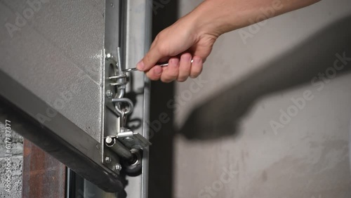 man adjusting automatic garage doors