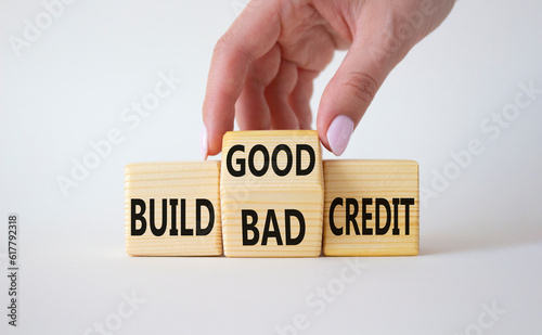 Build Good or Bad Credit symbol. Businessman hand turns wooden cubes and changes the words Build Bad Credit to Build good credit. Beautiful white background. Business concept. Copy space