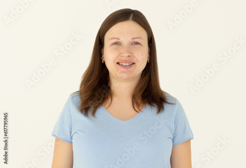 Close-up portrait of yong woman casual portrait in positive view, big smile, beautiful model posing in studio over white background. Caucasian portrait woman.