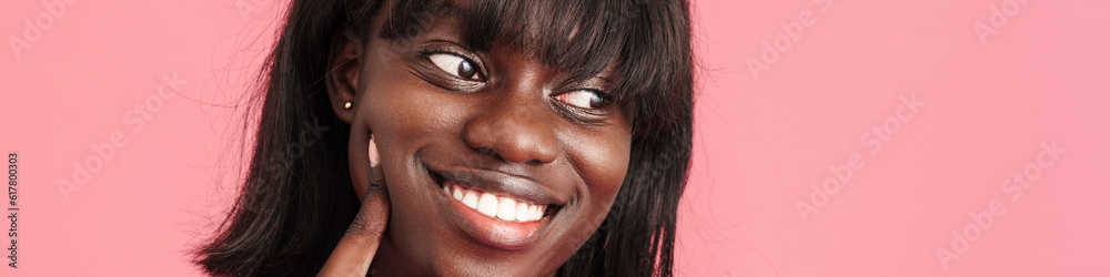 Portrait of young beautiful happy smiling african woman touching cheek Portrait of young beautiful happy smiling african woman touching cheek