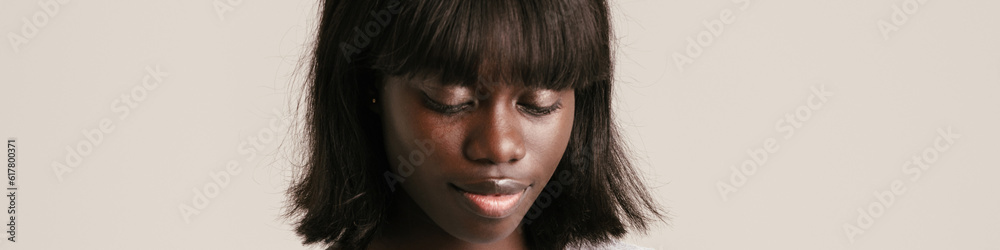 Young beutiful calm african woman with bob haircut using phone Young beutiful calm african woman with bob haircut using phone