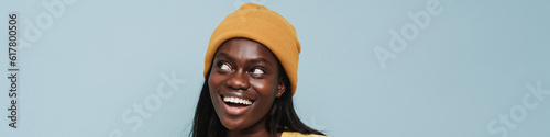 Young beautiful smiling african woman in t-shirt and winter hat