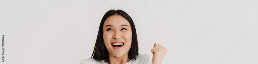 Asian excited woman playing video game on cellphone Asian excited woman playing video game on cellphone