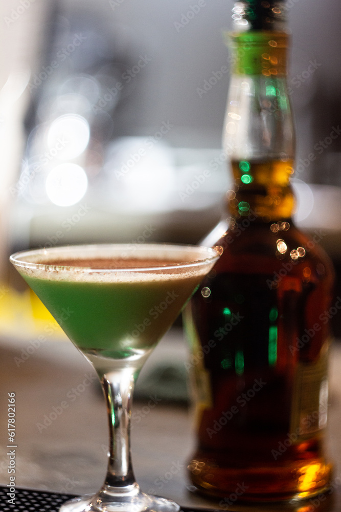 Summer alcohol drink. Tiramisu cocktail in a glass on a tall stem with copy space and a bar background. Summer alcohol drink. Tiramisu cocktail in a glass on a tall stem with copy space and a bar background.