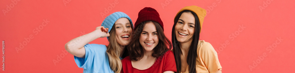 Three young happy girls smiling and posing at camera Three young happy girls smiling and posing at camera