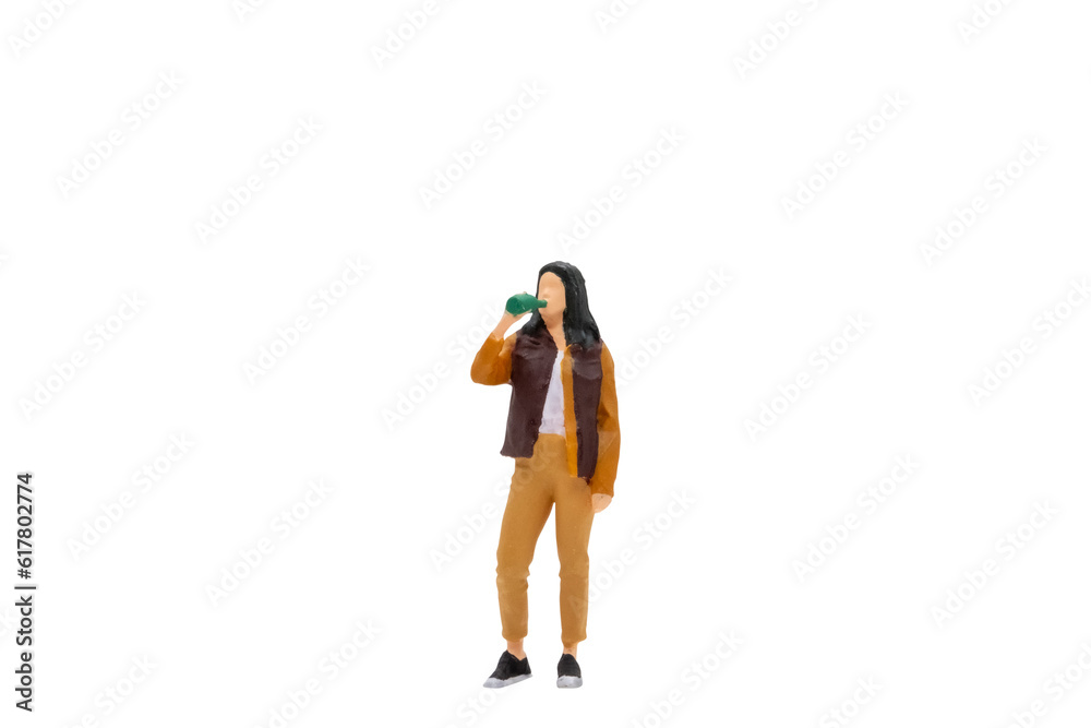 Miniature people Young woman drinking water from bottle isolated on white background with clipping path