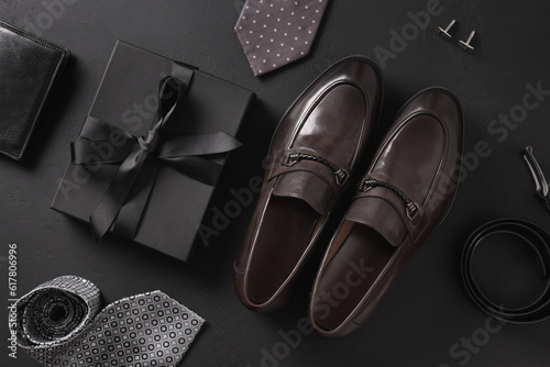 Set of classic mens accessories - shoes, belt, wallet and gift on black background. Top view. Flat lay. Concept mens design and Fashion. Father's Day.
