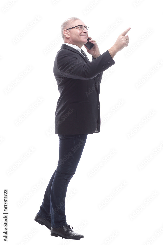 in full growth. businessman talking on a smartphone in full growth. businessman talking on a smartphone