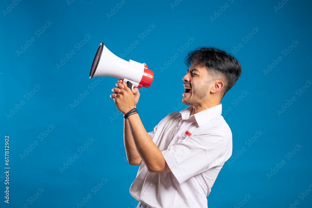 Indonesian high school students shout using megaphones Indonesian high school students shout using megaphones
