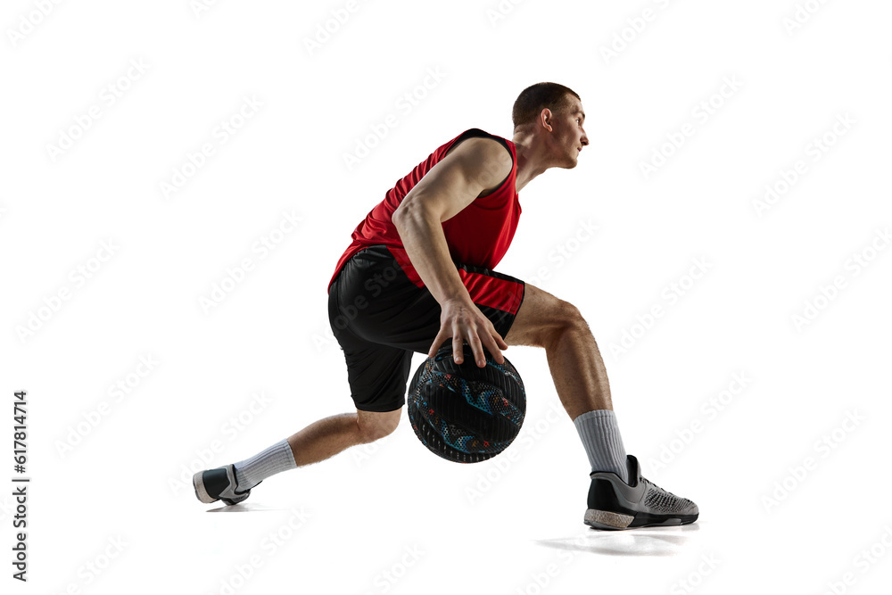 Dribbling. Young concentrated man, basketball player in motion during game isolated against white background. Concept of sport, action and motion, health, game, hobby, sportswear, ad Dribbling. Young concentrated man, basketball player in motion during game isolated against white background. Concept of sport, action and motion, health, game, hobby, sportswear, ad