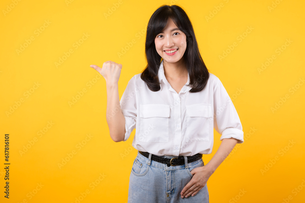 Businesswoman. young asian woman happy smile dressed in white shirt showing pointing finger hand gesture to free space isolated on a yellow background. presenting advertising advice promotion concept. Businesswoman. young asian woman happy smile dressed in white shirt showing pointing finger hand gesture to free space isolated on a yellow background. presenting advertising advice promotion concept.