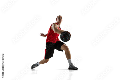 Young man, professional basketball player during game, training, running with ball isolated against white background. Concept of sport, action and motion, health, game, hobby, sportswear, ad