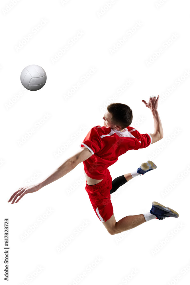 Dynamic image of young sportive man, professional volleyball player in red uniform in motion, hitting ball on white studio background. Concept of sport, active lifestyle, health, dynamics, game, ad