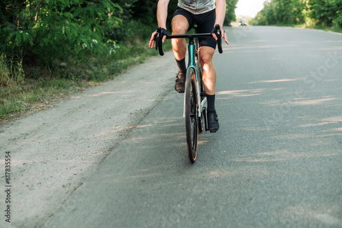 Close-up of a road bike with a cyclist in motion while riding around town.