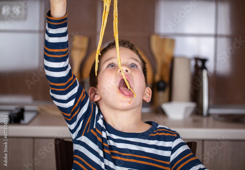 happy beautifl kid eat spaghetti