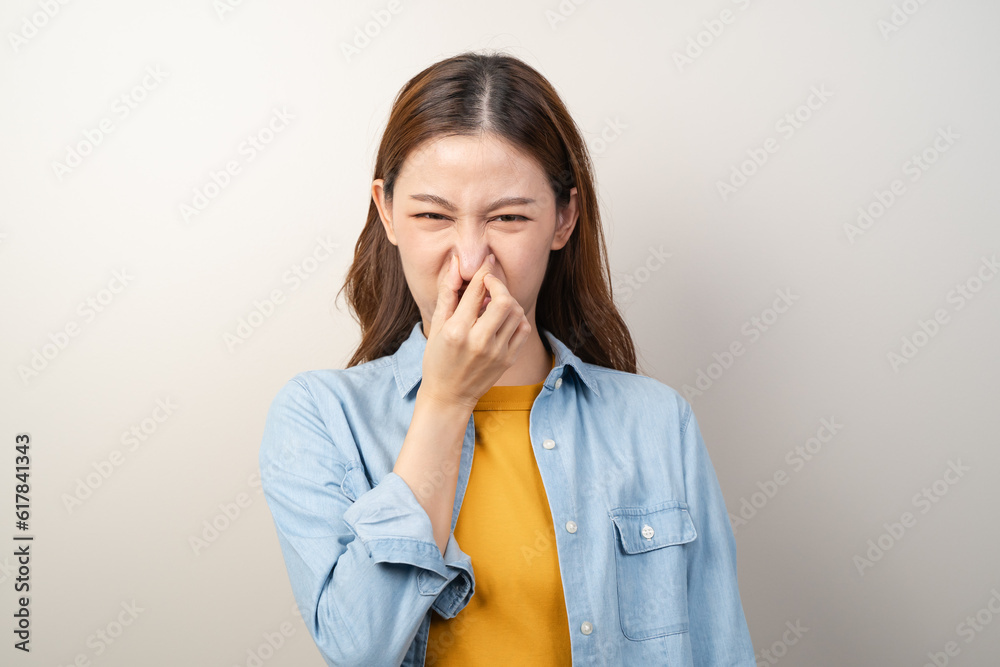 Asian woman smelling bad stink odors.