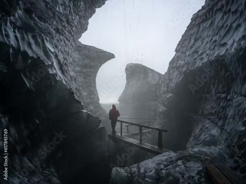 A peson wallking out of Katla Ice Cave, Mýrdalsjökull Glacier, South Iceland. photo