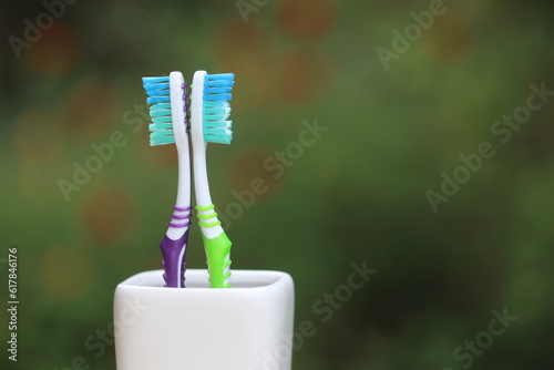 Toothbrush in plastic holder. Nylon bristles and plastic handles. 