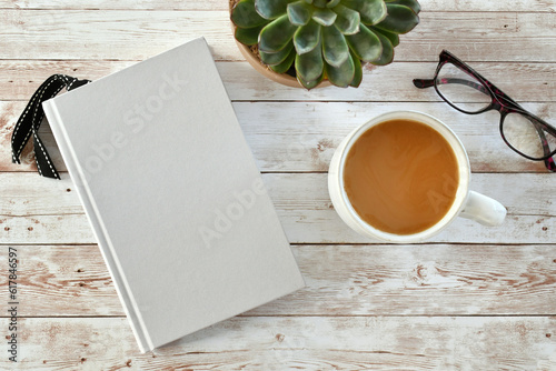 Stampa su tela Blank book cover for mock up with coffee, plant and reading glasses