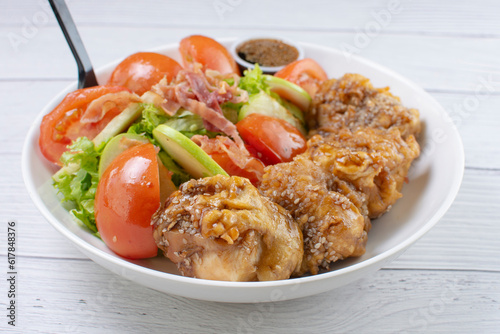 Obraz na płótnie protein bowl and salad, accompanied by pieces of chicken in sweet and sour sauce, tomatoes in lemon, lettuce, apple, pieces of bacon in teriyaki sauce w salonie