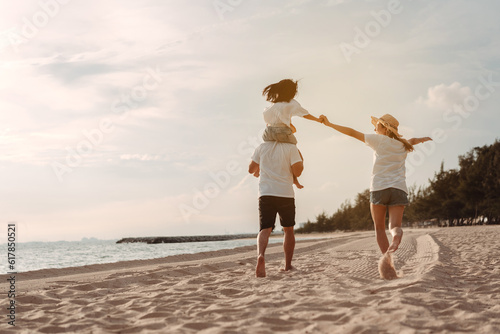 Happy asian family enjoy the sea beach. father, mother and daughter having fun playing beach in summer vacation on the ocean beach. Happy family with vacation time lifestyle concept.