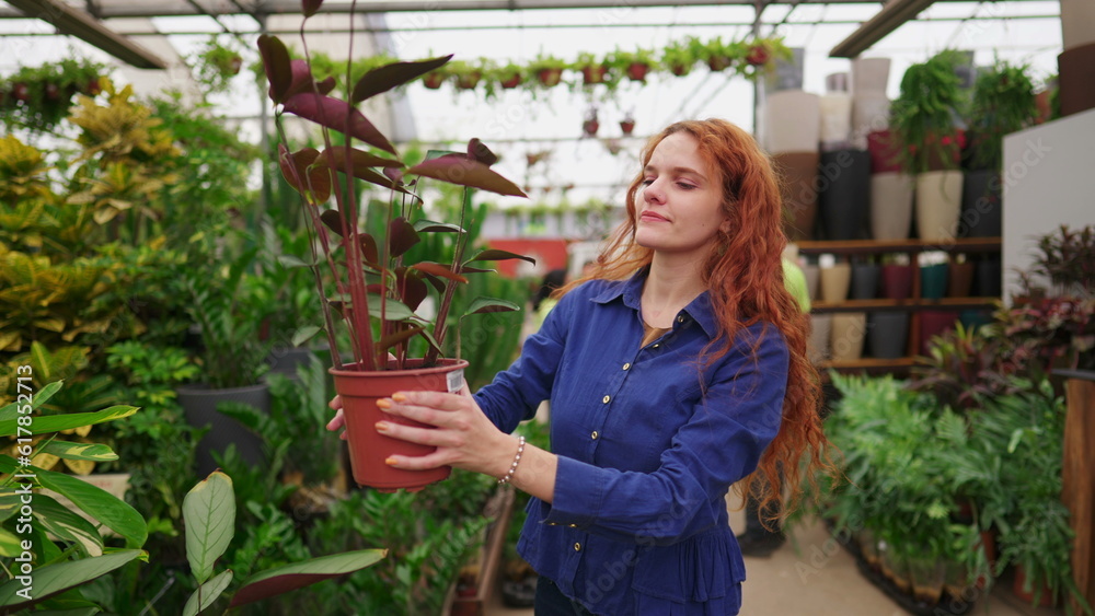 Joyful Woman Picking Plant from Shelf, Strolling Through Horticulture Gardening Supply Store Aisle Joyful Woman Picking Plant from Shelf, Strolling Through Horticulture Gardening Supply Store Aisle