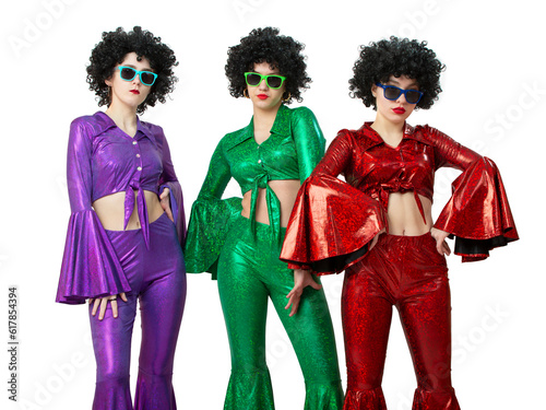 A group of disco girls in African American wigs and colorful costumes on a white background. Fashion of the seventies and eighties.