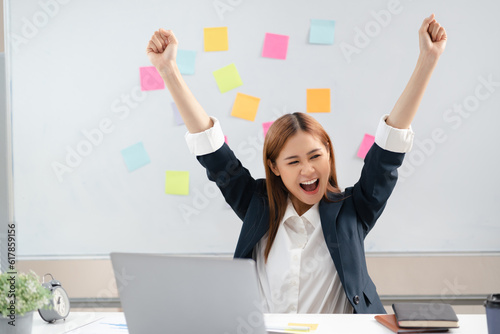 Excited business woman surprise looking on laptop having a good news.