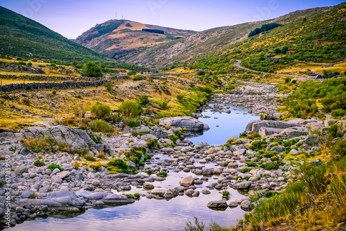 Panoramic of the Barbellido river with its round stones from the El Mellizo refuge area in the Sierra de Gredos photo