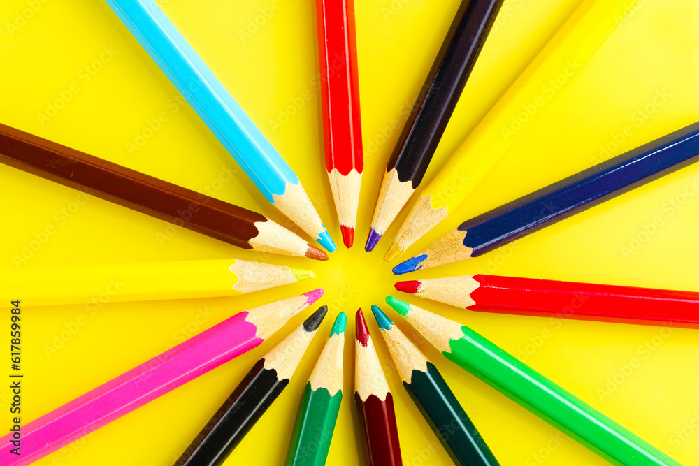 Multicolored pencils on yellow background Multicolored pencils on yellow background