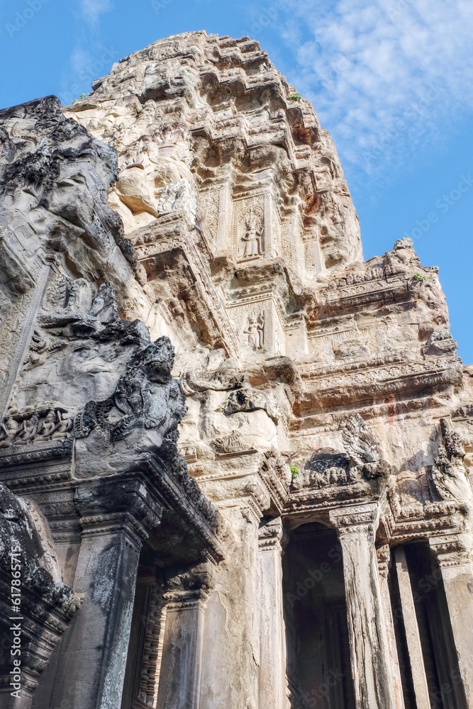 A mesmerizing view of the carved stone walls depicting historical narratives at the ancient Angkor Temple, Cambodia. A mesmerizing view of the carved stone walls depicting historical narratives at the ancient Angkor Temple, Cambodia.