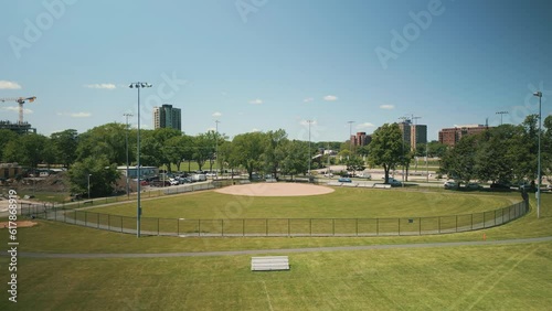 Aerial View Softball and Baseball Field in Downtown Halifax, Canada Filmed with a Cinematic Drone During the Daytime with Green Grass and Trees on a Summer Day. photo