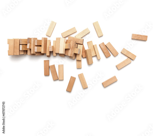 Concept of risk and destruction -A pile of small wooden blocks from a collapsed tower on a white background