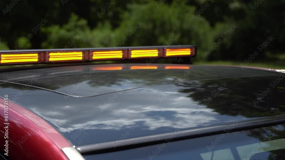 Flashing yellow emergency light on car roof. Flashing amber warning
