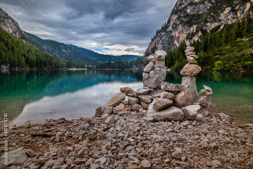 Stone piles at the coast of the Lago di Braies in the Dolomites, Italy © petertakacs