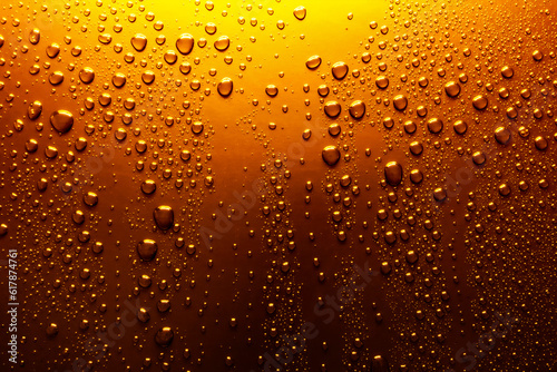 Close-up of water drops on yellow-orange surface  background