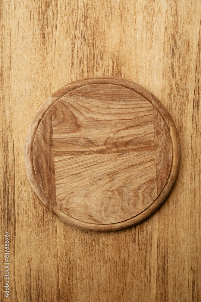 Empty round pizza board on wooden old background, top view Empty round pizza board on wooden old background, top view