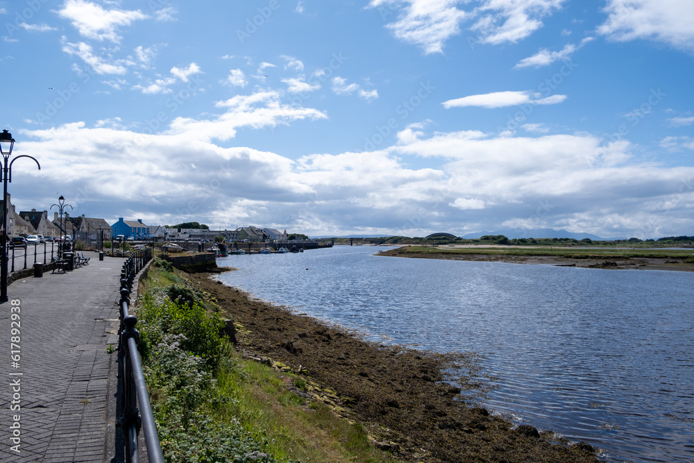Obraz premium Looking Along Irvine Harbour North Ayrshire Scotland on a bright day in April with Arran in the Hazy Distance