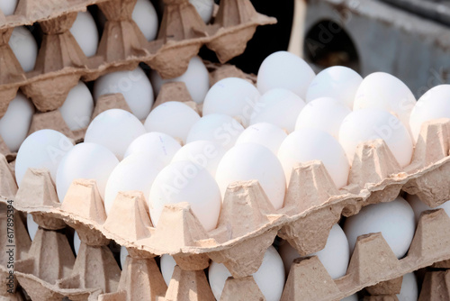 Chicken white eggs in paper packaging. The concept of a farmer's market, a dietary product.