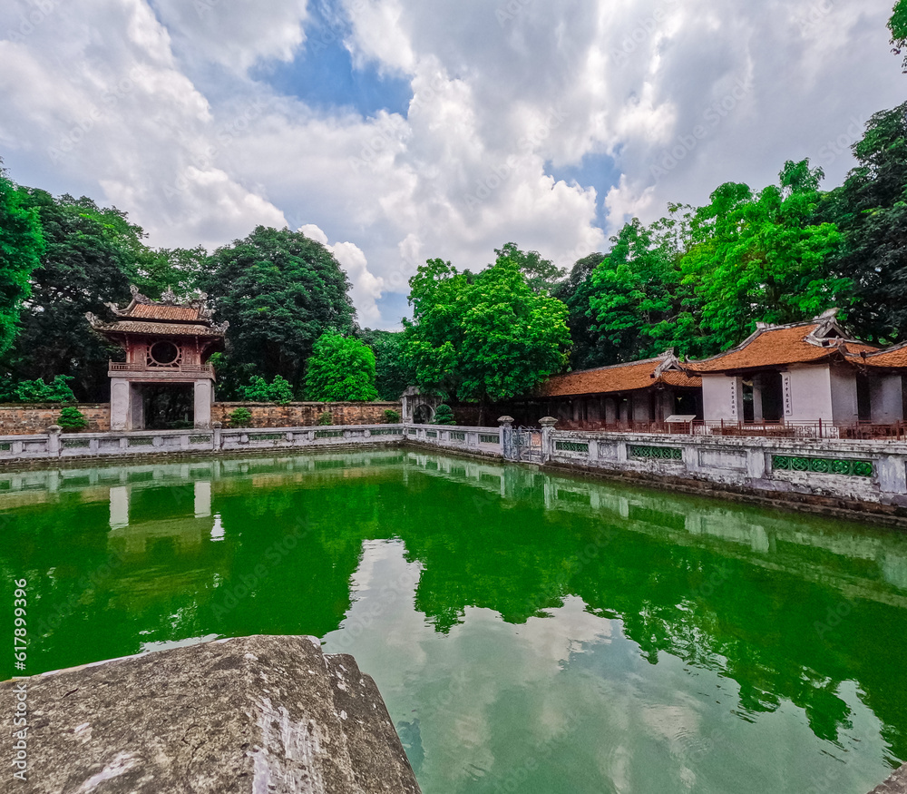 Fototapeta premium Literature Temple surrounded by beautiful gardens old historic buildings Bonsai plants and old trees in Hanoi Vietnam