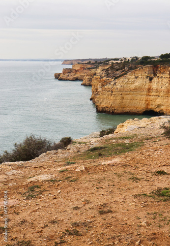Row of cliffs next to Atlantic Ocean on a winter day in southern Portugal on the Seven Hanging Valleys Trail.