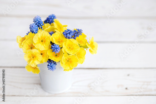 Bouquet of yellow and blue flowers on a white table