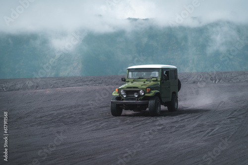 Travelling jeep driving trip in Bromo mount volcano territory. Vehicle journey in Semeru savanna field