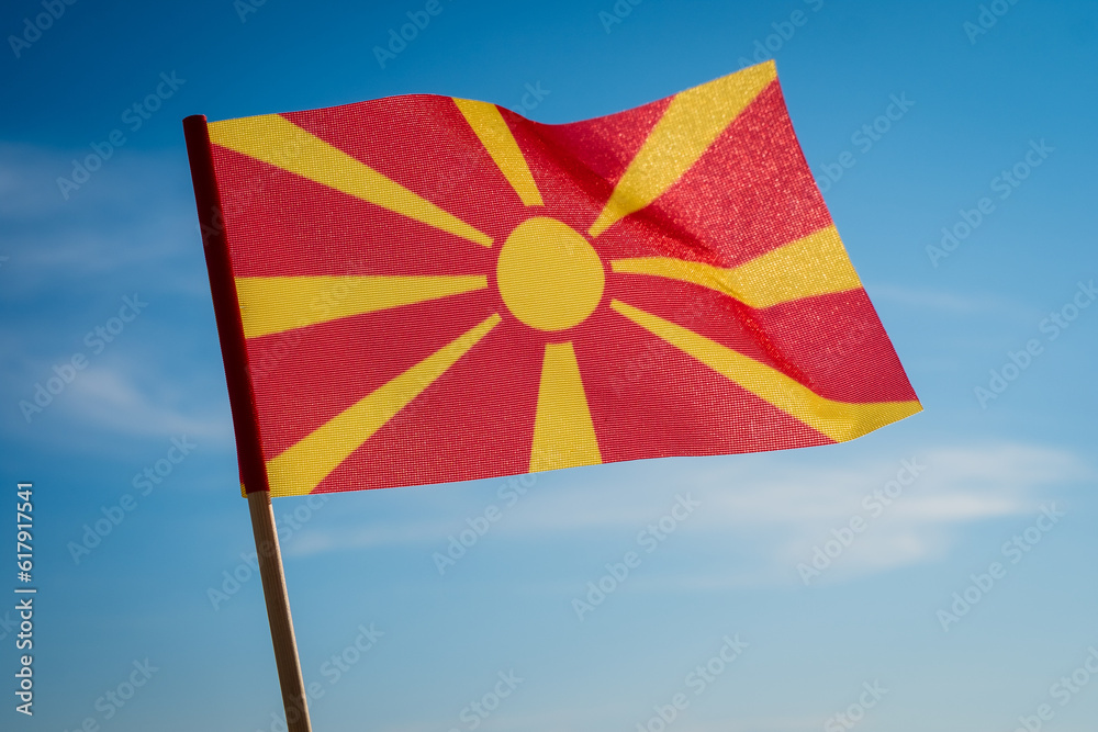 Flag of North Macedonia on blue sky background.