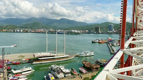 Ferry wheel passengers point of view from cabin to cityscape panorama of Batumi. Black sea harbor and boats fun cruise famous visit destination in Georgia photo