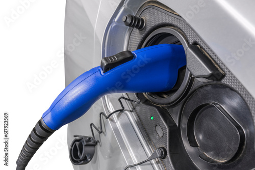 Close up of electric vehicle plug charging car isolated with cut out background.