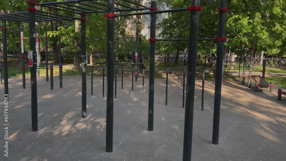An empty sports field in a Moscow park by summer day. Chinning bars, sports equipment, crossbars An empty sports field in a Moscow park by summer day. Chinning bars, sports equipment, crossbars