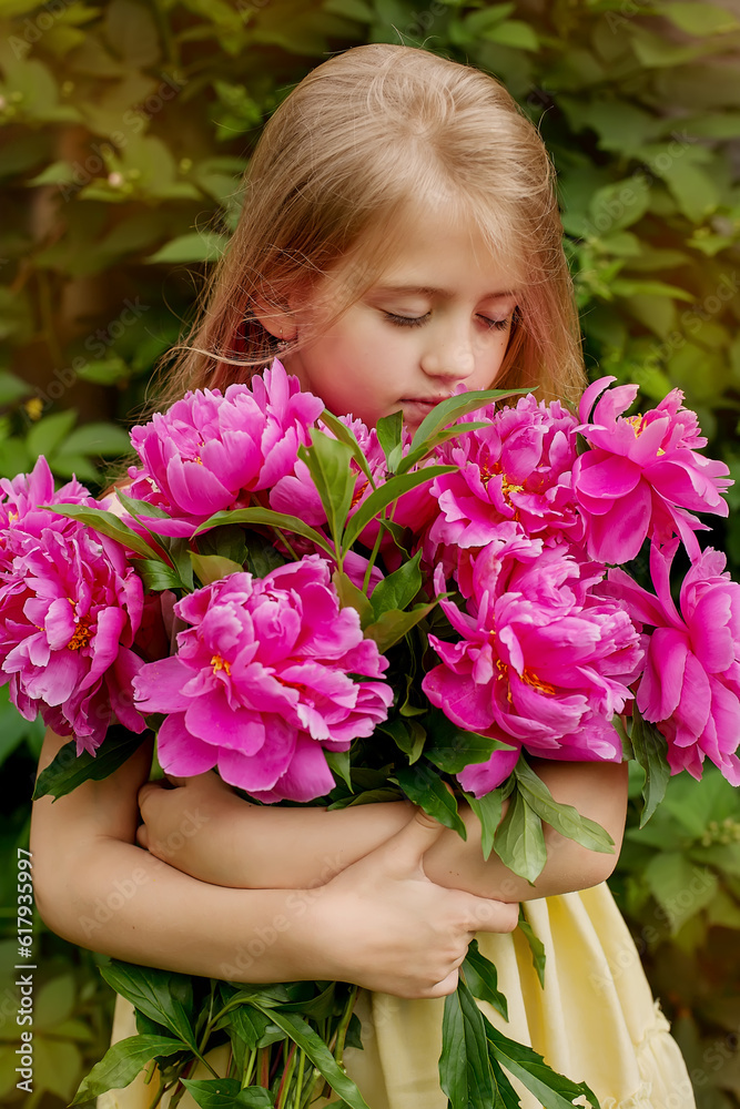 a beautiful blonde girl with long hair holds a bouquet of pink peonies in her hands
